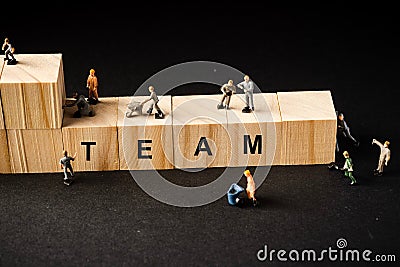 Miniature builders figure with wooden blocks with â€œTEAMâ€ wordings Stock Photo